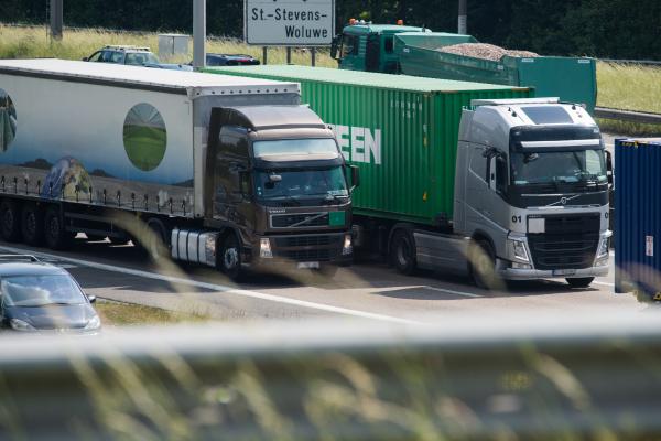 Busses, commercial vehicles, vans and lorries driving on a motorway